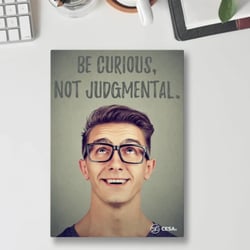  A motivational poster with the phrase “Be Curious, Not Judgmental” in bold text. The design shows a smiling person looking upward with the CESA 6 logo at the bottom. Wellness Posters Wellness Posters