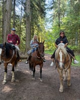 Ted, his wife and his daughter riding horses