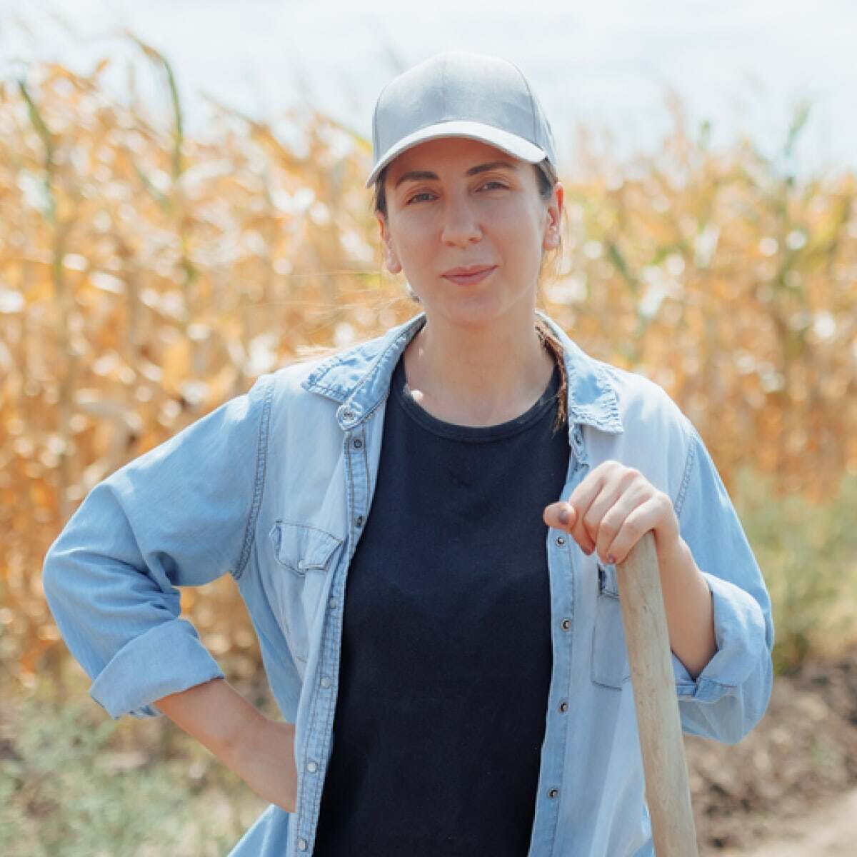Woman standing in cornfield