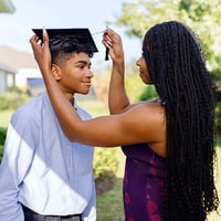 high school graduate with proud parent
