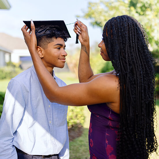 high school graduate with proud parent