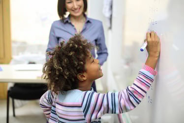 Student writing on white board