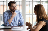 Male in a coaching conversation with a female colleague 