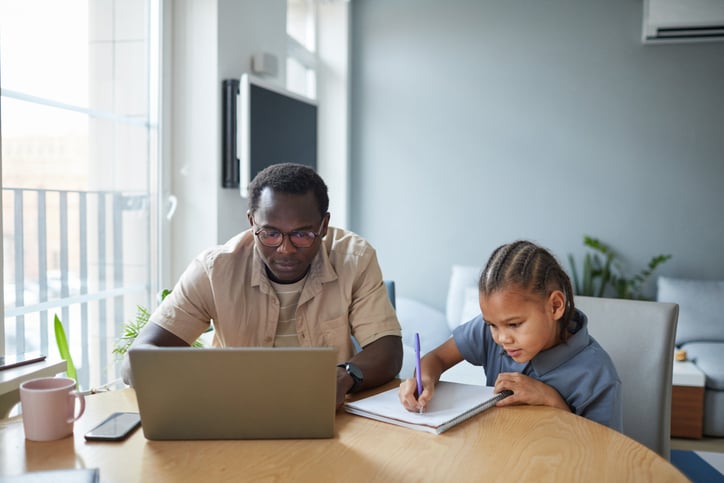 Parent using a laptop to access school information