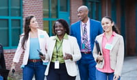 Group of teachers walking together outside a school