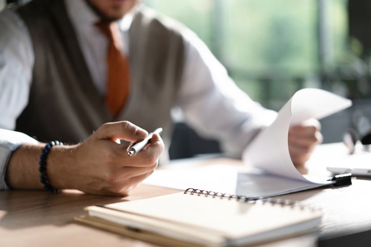 School administrator reviewing paperworks at desk