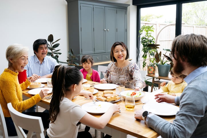 multi-generational family talking at a dinner table