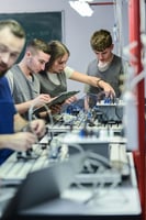 students working on electronics in a lab
