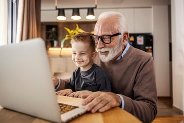 Grandfather and grandson looking at computer