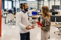 Leader and team member talking in an office
