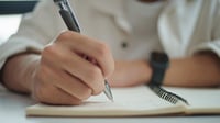 Student taking notes in a notebook