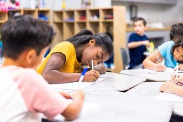 Students writing in a notebook