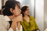 An adult female reflecting during a conversation