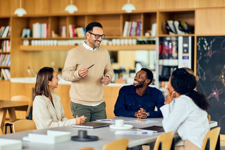 School leader talking with a small group of staff members