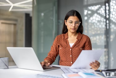 School administrator reviewing documents in office