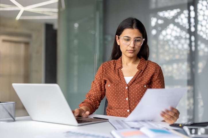 School administrator reviewing documents in office