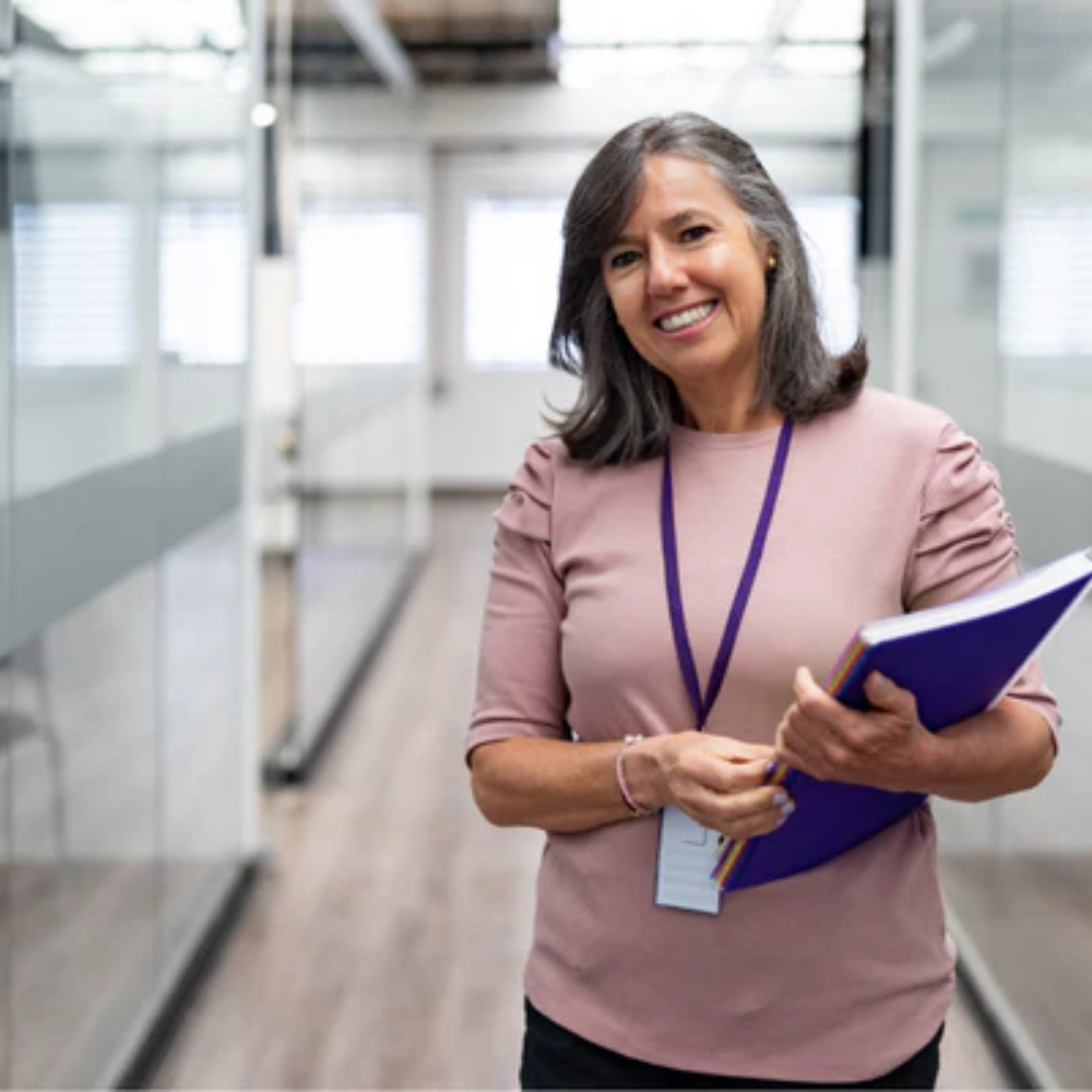 Woman smiling at camera holding book
