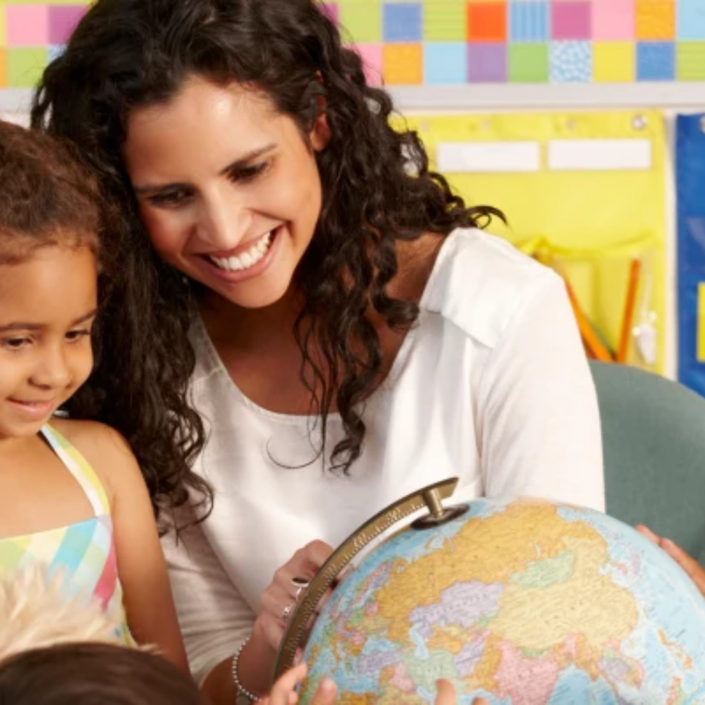 Woman teaching child about a globe