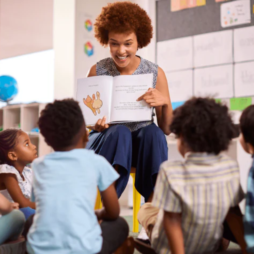 Woman reading a book to children