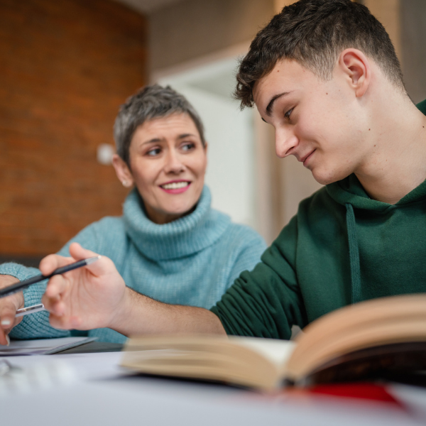 Teacher assisting a high school student with individual tutoring