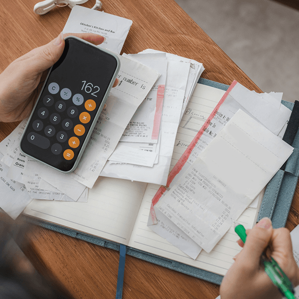 woman budgeting with calculator and receipts